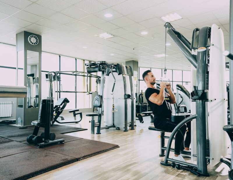 woman in black tank top and black pants exercising
