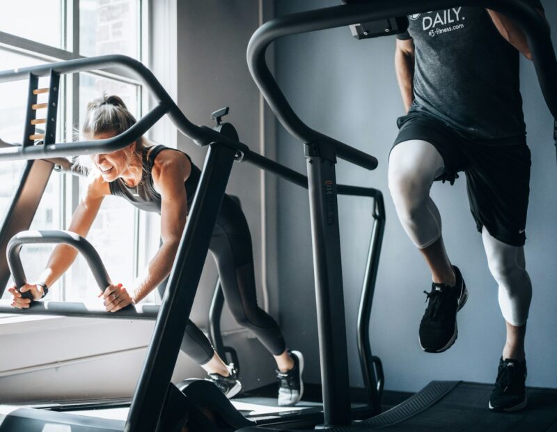 woman in black tank top and black shorts sitting on black exercise equipment